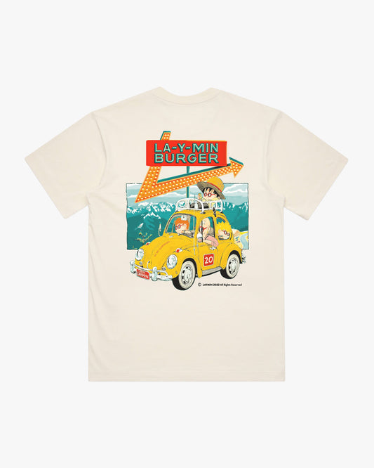 Cream t-shirt with a graphic of a yellow car and text on a mountain background