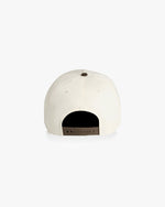 Back of natural color hat with brown snapback