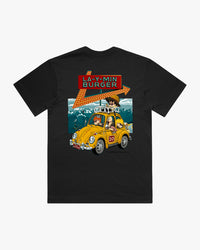 Black t-shirt with a graphic of a yellow car and text on a mountain background