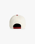 Back of natural color cap with red snapback