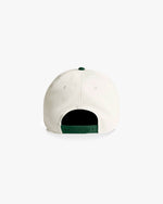 White baseball cap with green interior on a white background