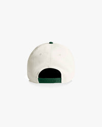 White baseball cap with green interior on a white background